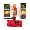 Siam Pad Thai noodle kit with sauce bottle, noodles package, and red towel on a white background